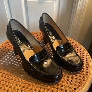 Michael Kors size 7 patent leather close-toed penny loafer heel.